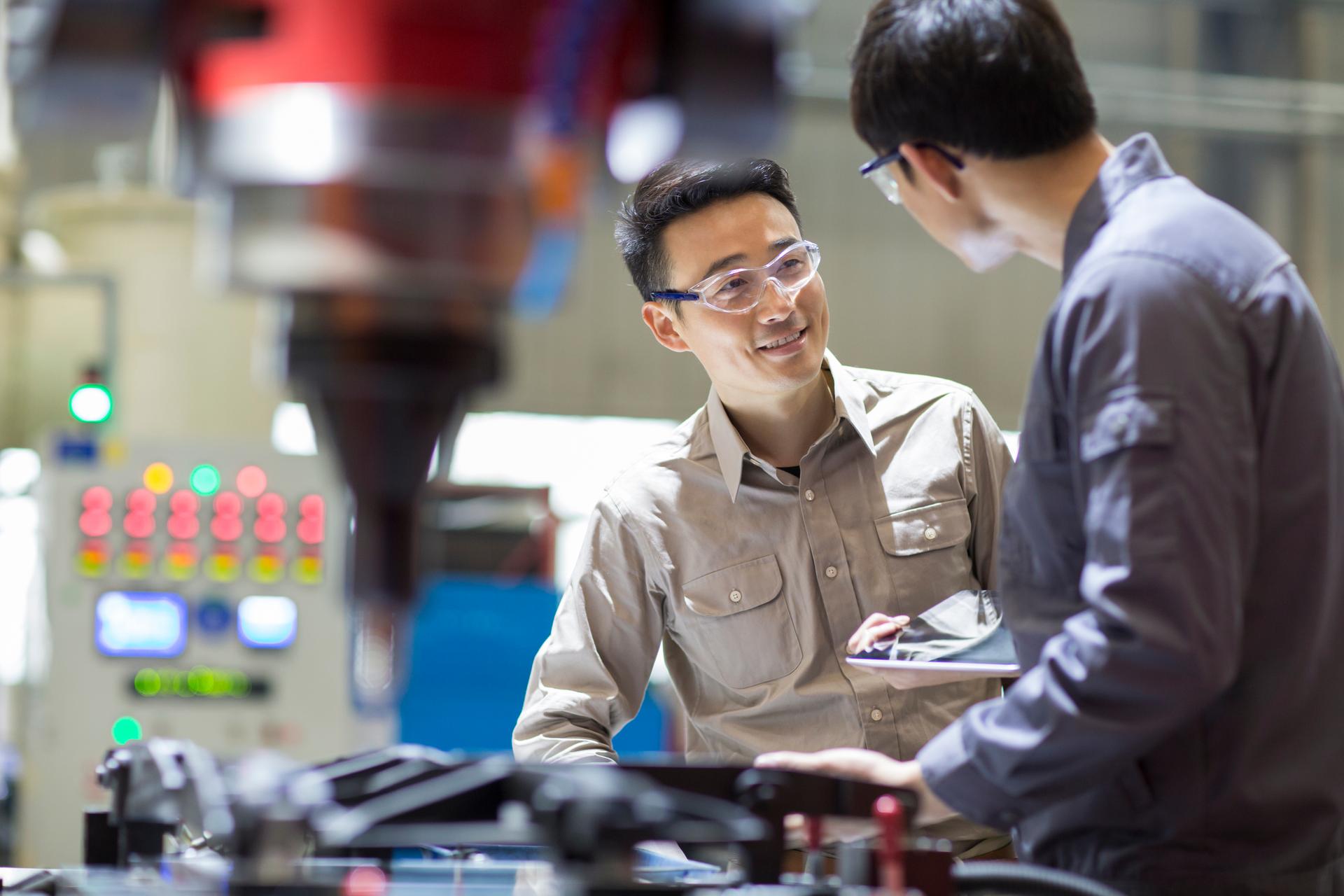 Young engineers talking in the factory