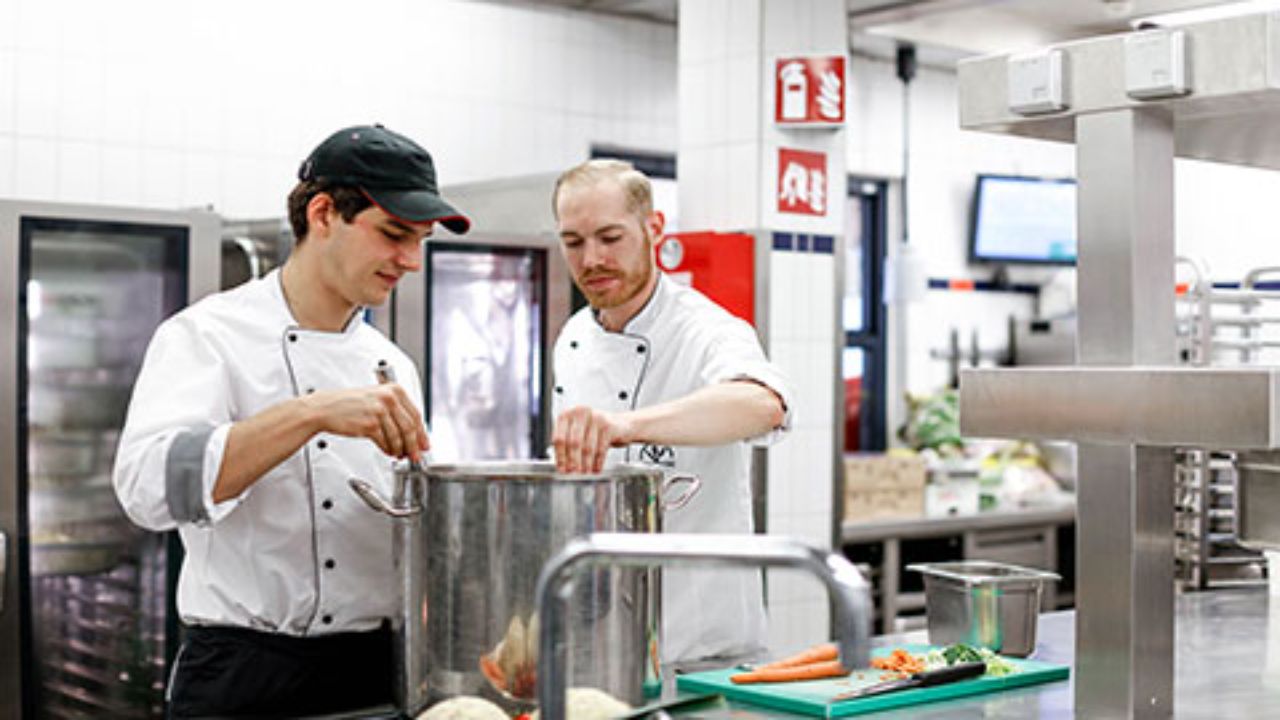 Two cooks working in the kitchen