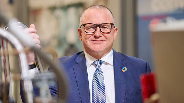 Portrait of Bjarne Foldager in a suit, smiling warmly