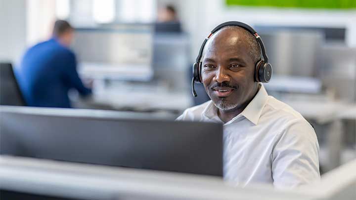 man with headset in fron of computer