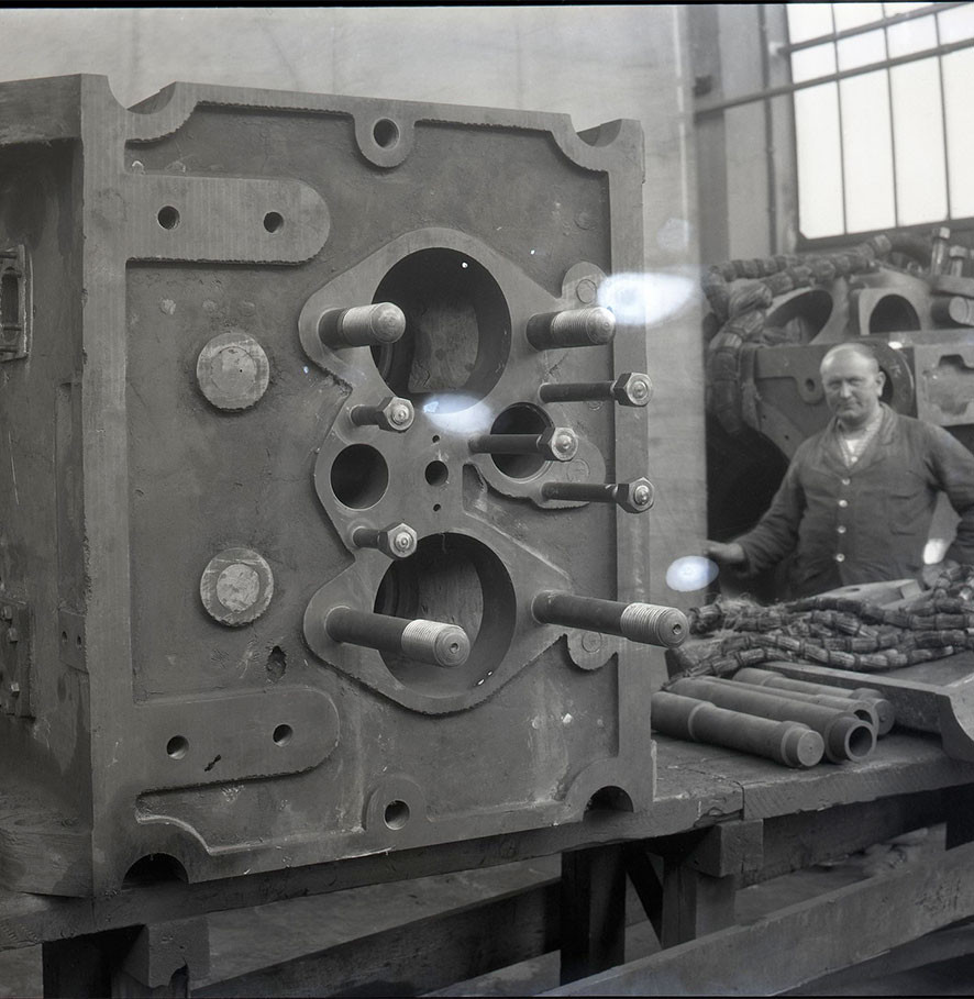 A B&W worker oversees production of a cylinder cover