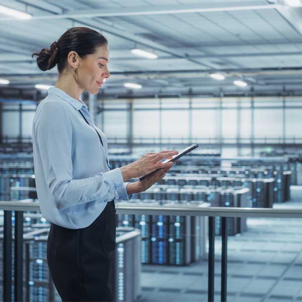 woman with ipad in server room