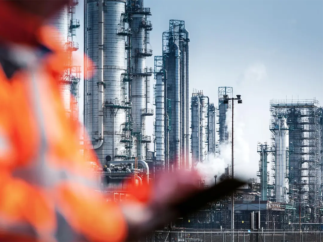 Industrial plant, out-of-focus service employee in the foreground