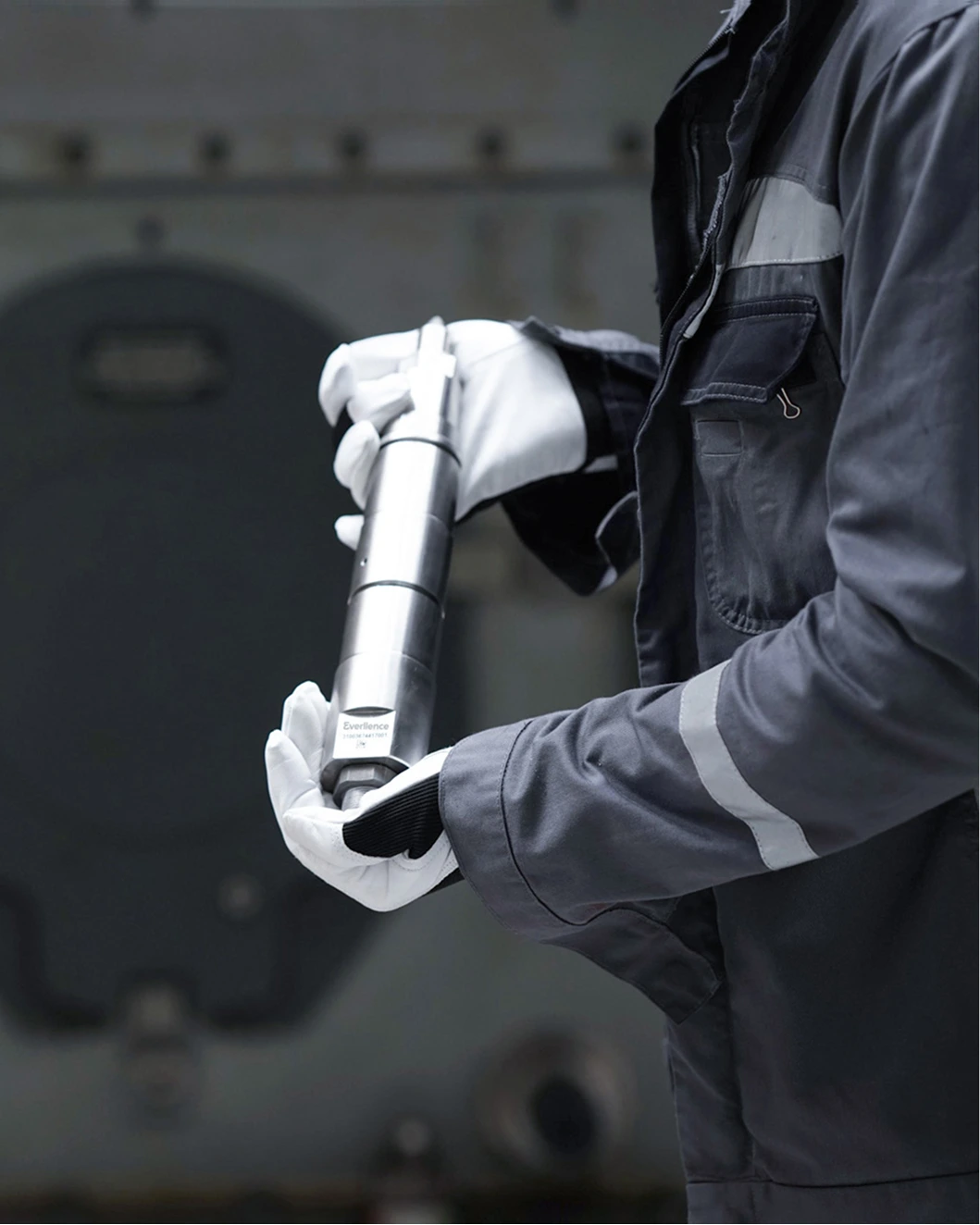 close up of an engineer holding a spare part