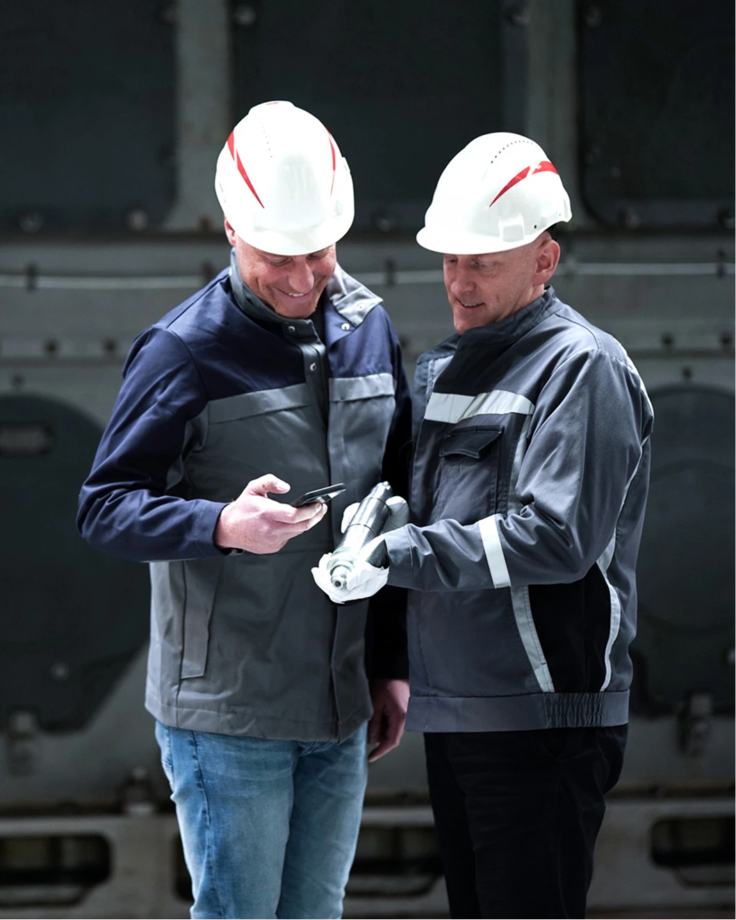 two engineers inspecting a spare part