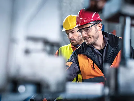 two service employee checking an engine
