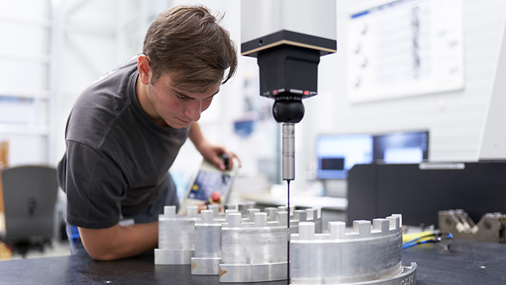 Apprentice inspects machine
