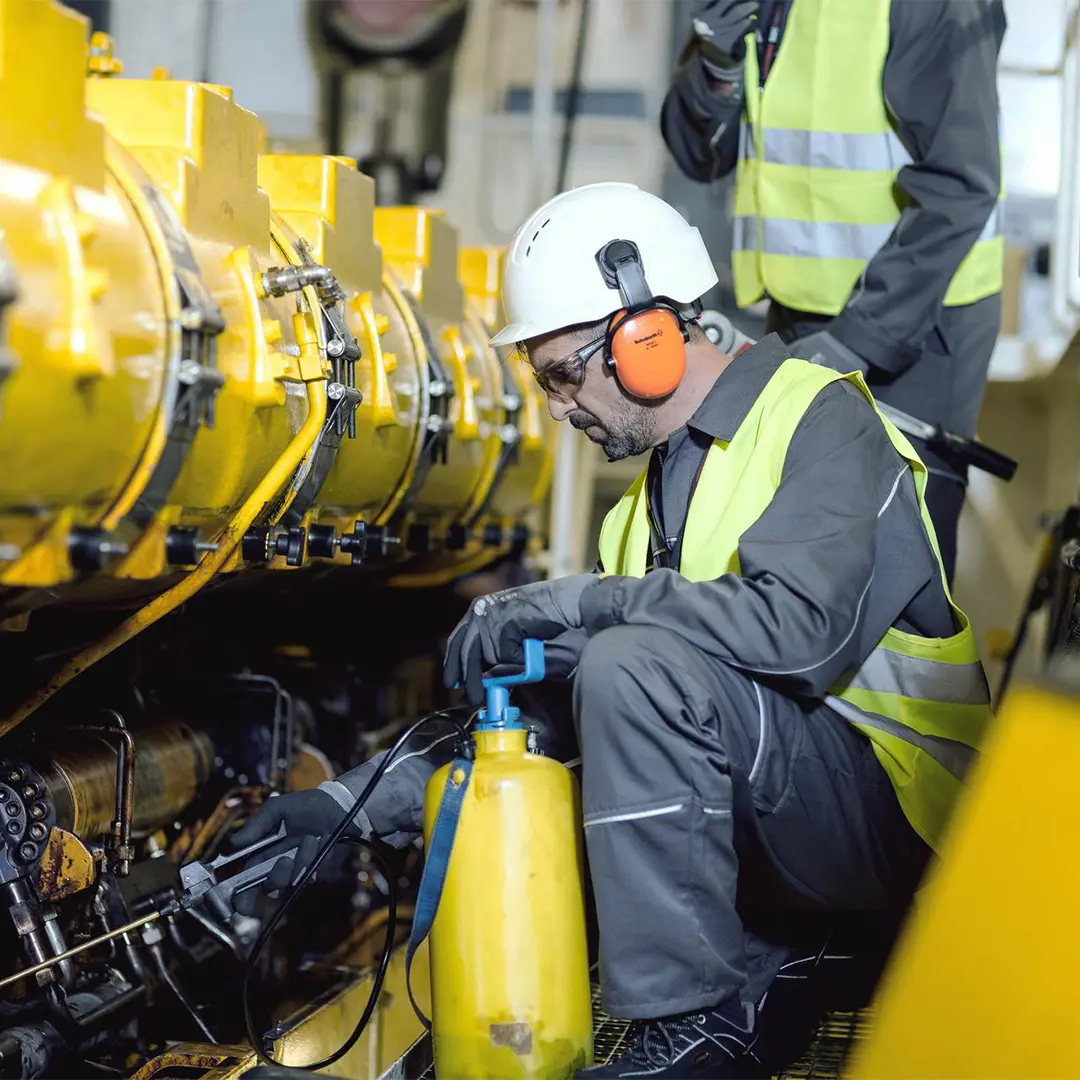Service employee inspecting an engine