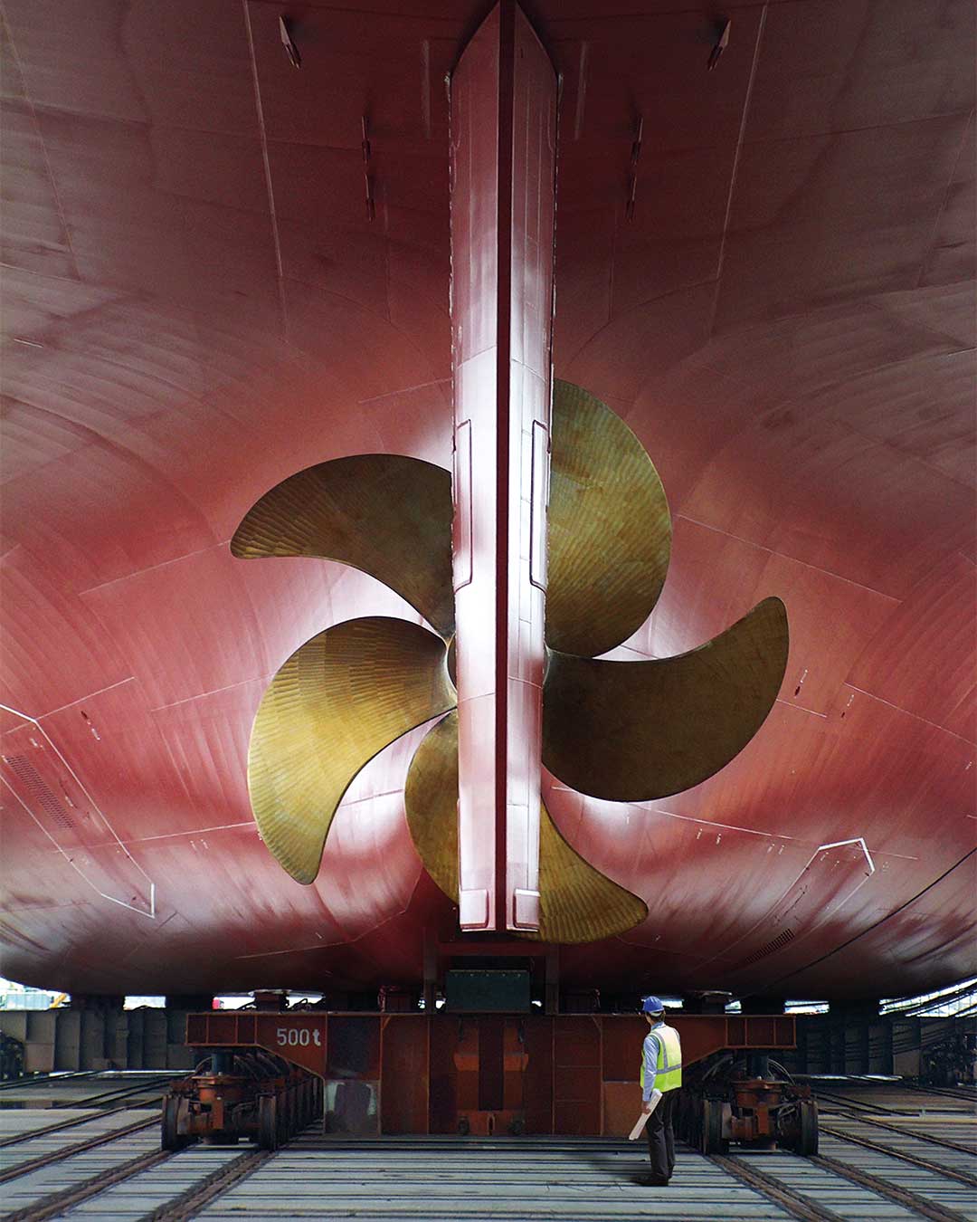 worker standing in front of a huge propeller