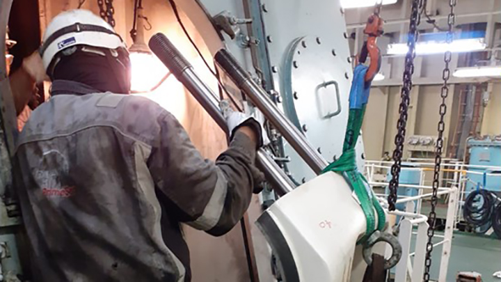 service employee working in the machine room of a ship