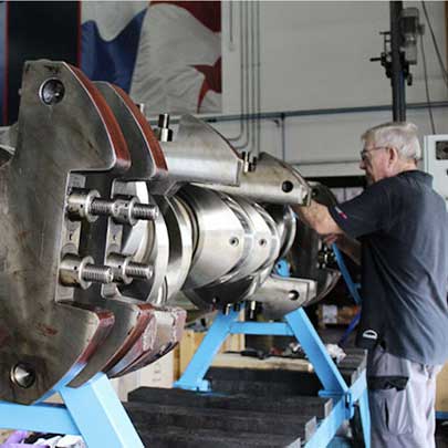 service employee in workshop working on some engine parts