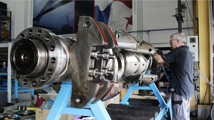 service employee in workshop working on engine parts