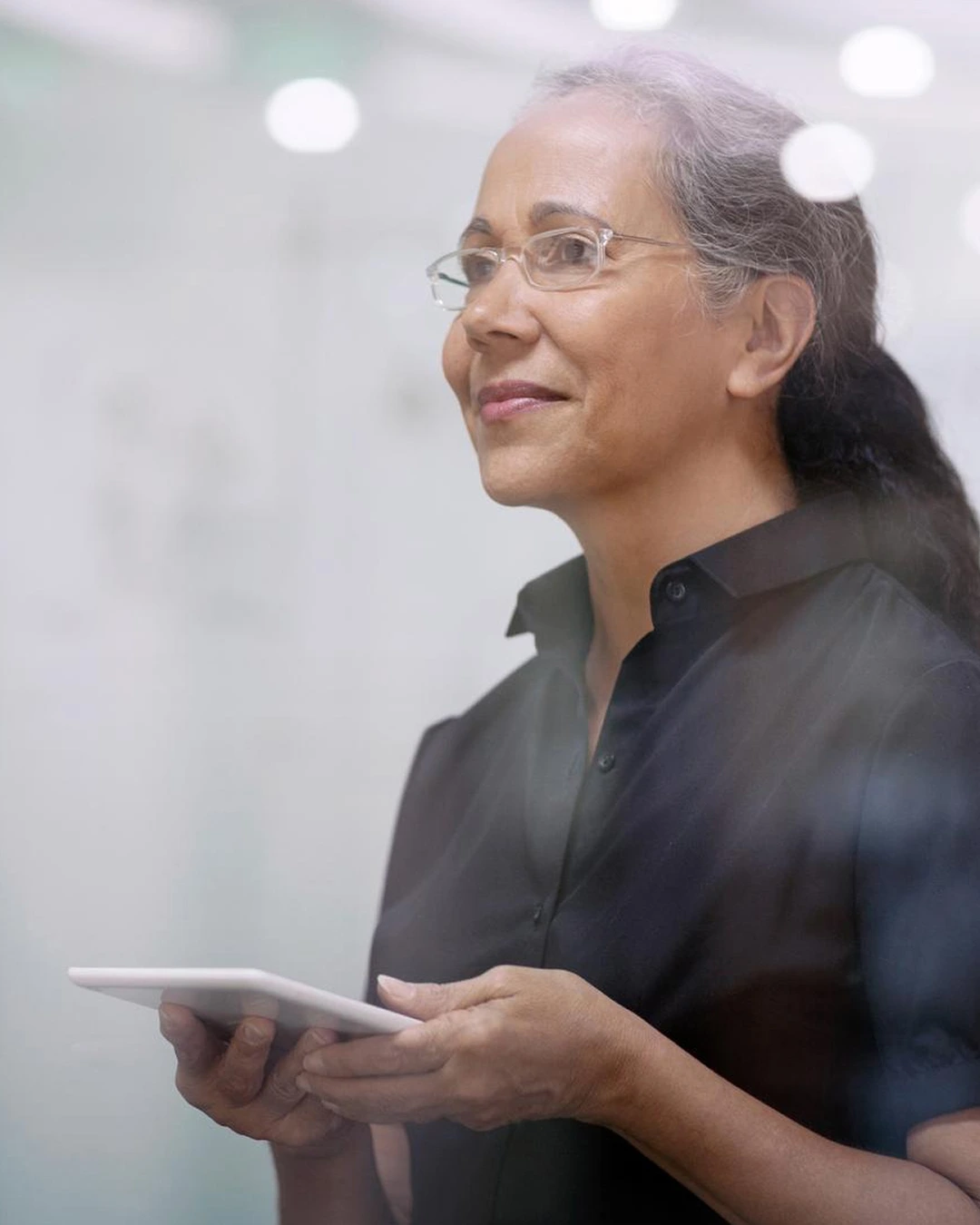 woman with ipad in her hands facing into future