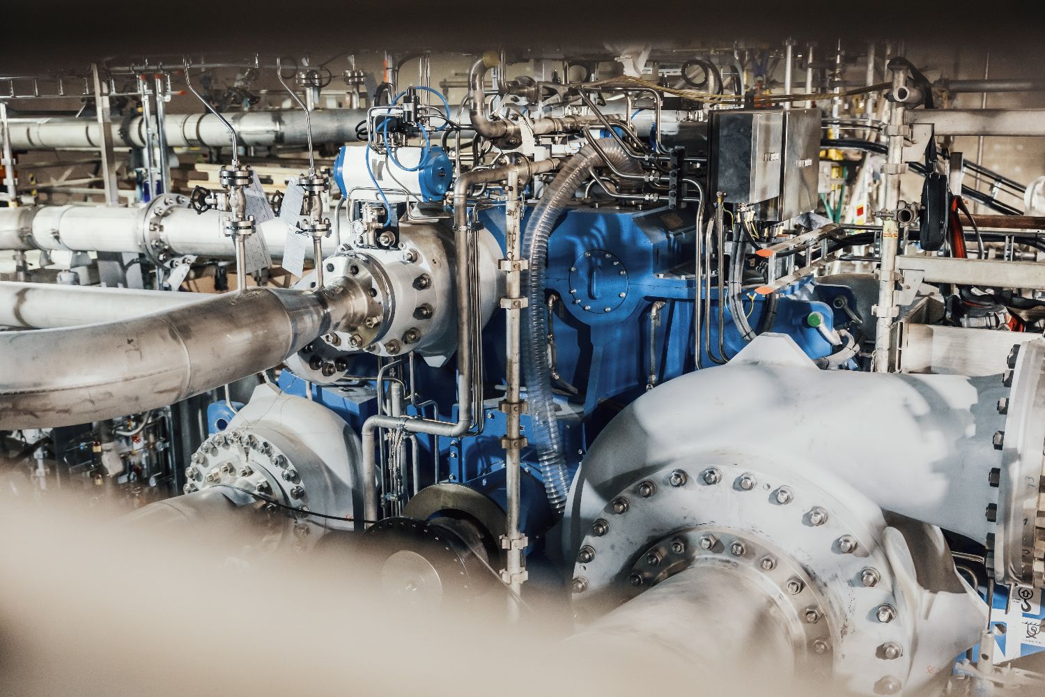 Detailed view of industrial carbon capture machinery featuring interconnected pipes, valves, and mechanical components, part of Heidelberg Materials’ CCS infrastructure.