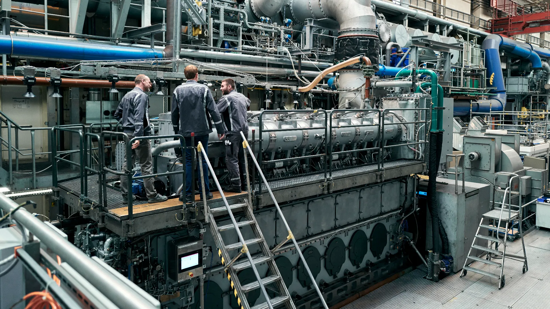 Inside the historic Everllence factory hall in Augsburg, engineers work on climate-neutral upgrades to traditional diesel ship engines.
