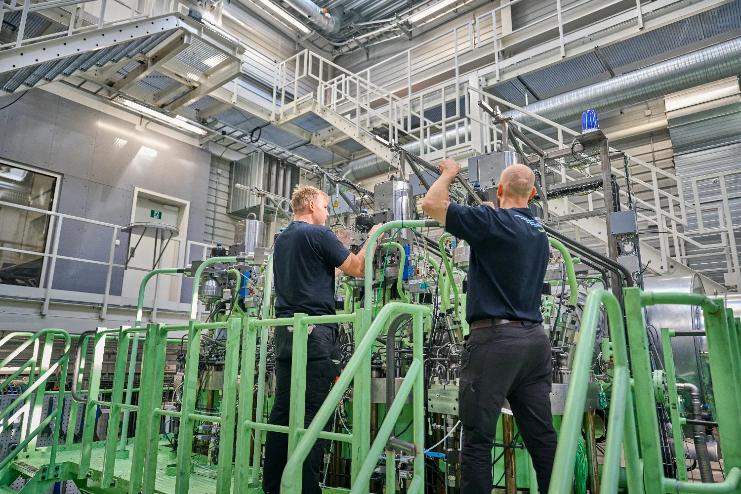 Engineers at the Everllence Research Centre in Copenhagen inspect and test a two-stroke ammonia-fueled engine developed for maritime decarbonization.