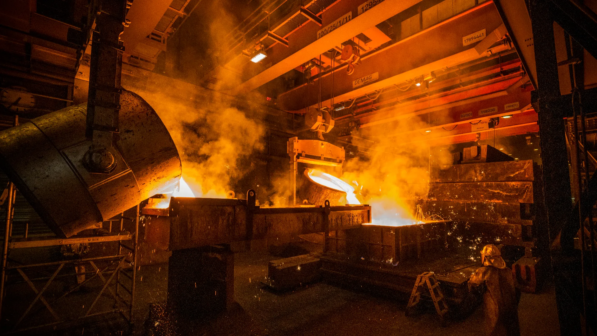 Large containers filled with molten iron are positioned for casting inside the Everllence foundry.