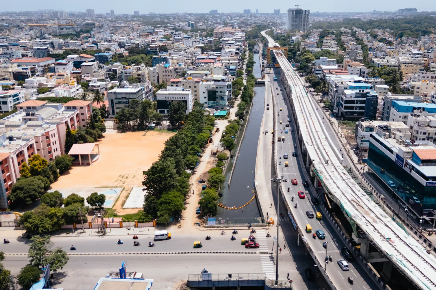 erial view of Bengaluru city with a visible canal where plastic waste interception systems are installed.