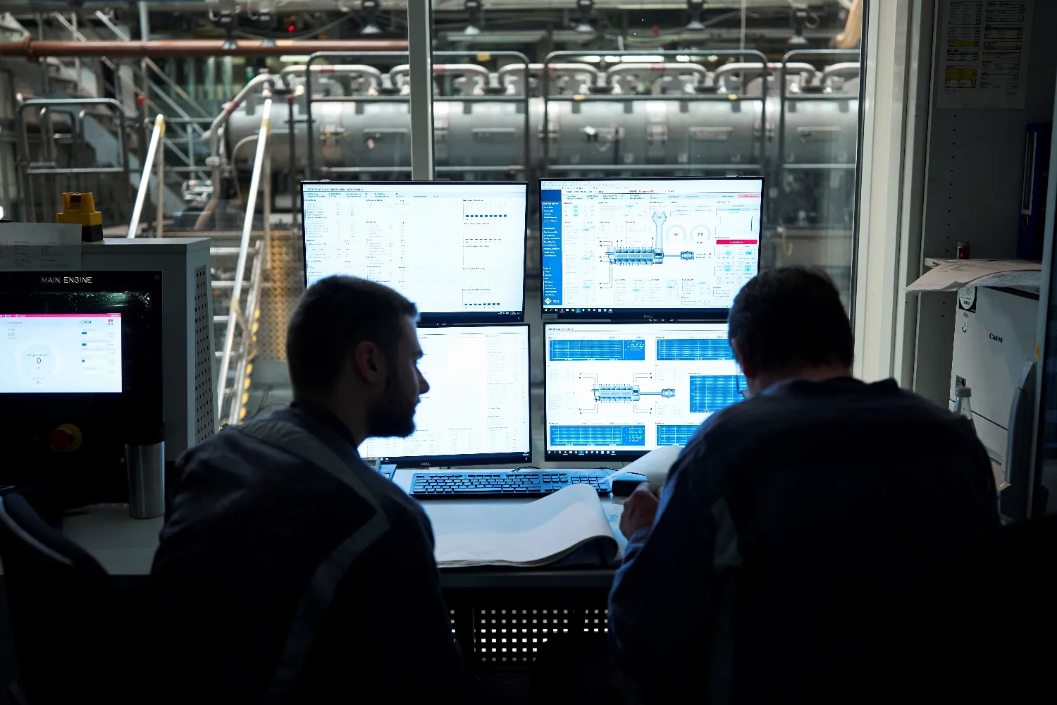 Engineers sit at computer workstations in the control room, analyzing data from methanol engine tests to optimize emissions and efficiency.