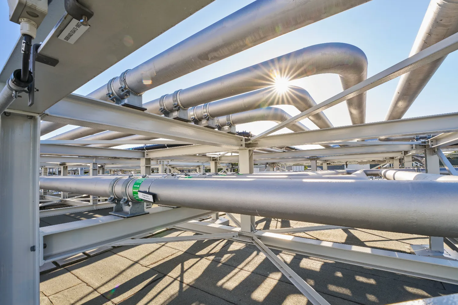 A close-up of metallic pipes and ducts forming part of the heat recovery system at the MHKW Chemnitz-Nord combined heat and power plant.
