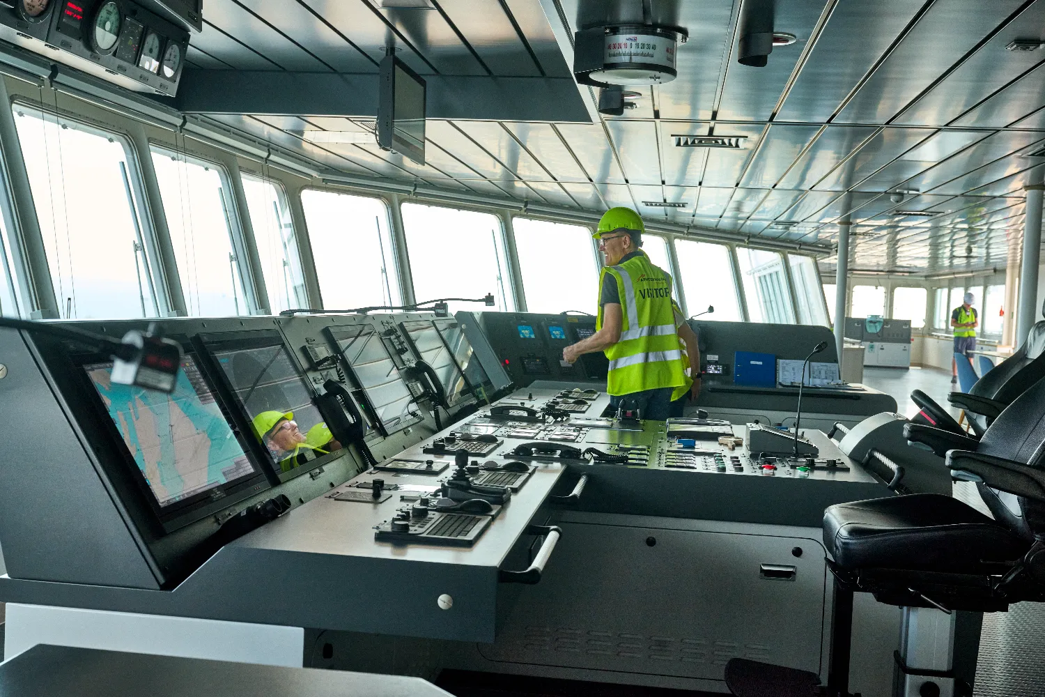 A crew member operates the bridge controls aboard the Antonia Mærsk, a container vessel running on green methanol.