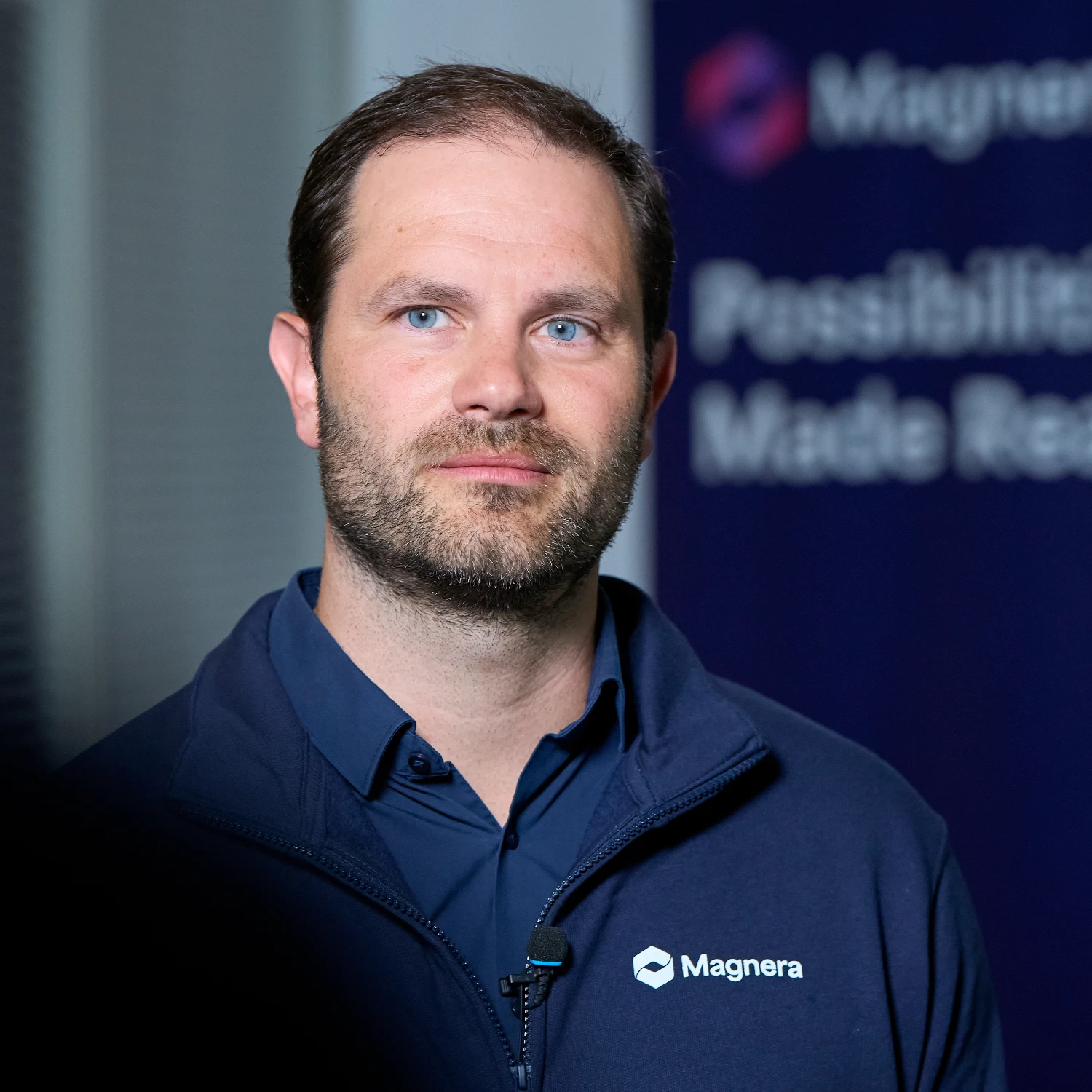 Portrait of Paul Stangenberg speaking in an industrial interview setting.