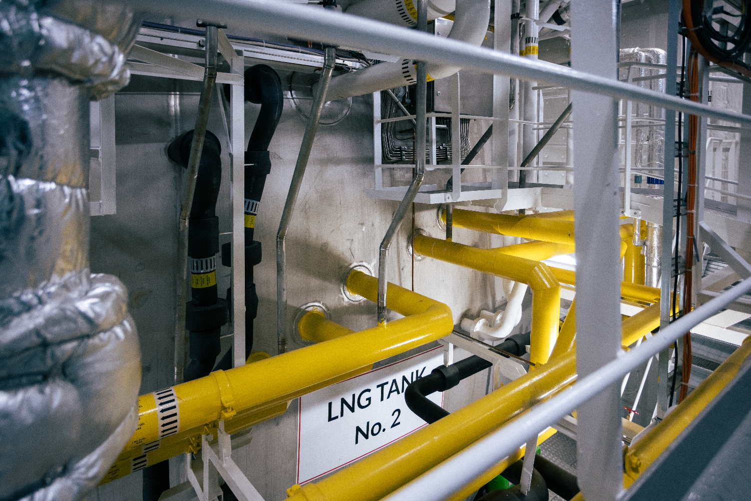Double-walled yellow LNG fuel pipes inside MyStar’s engine room.