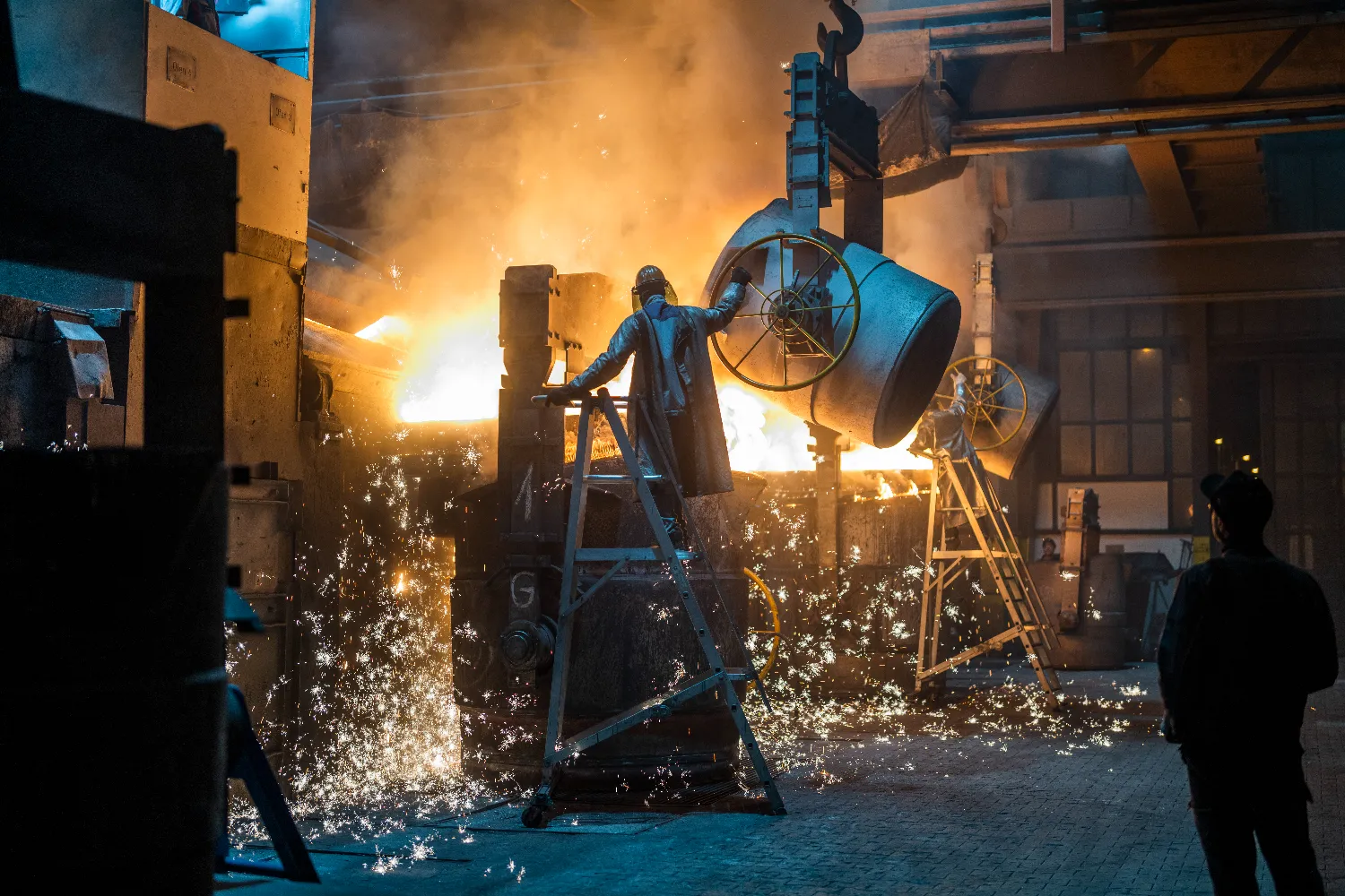 Sparks fly as workers handles hot materials