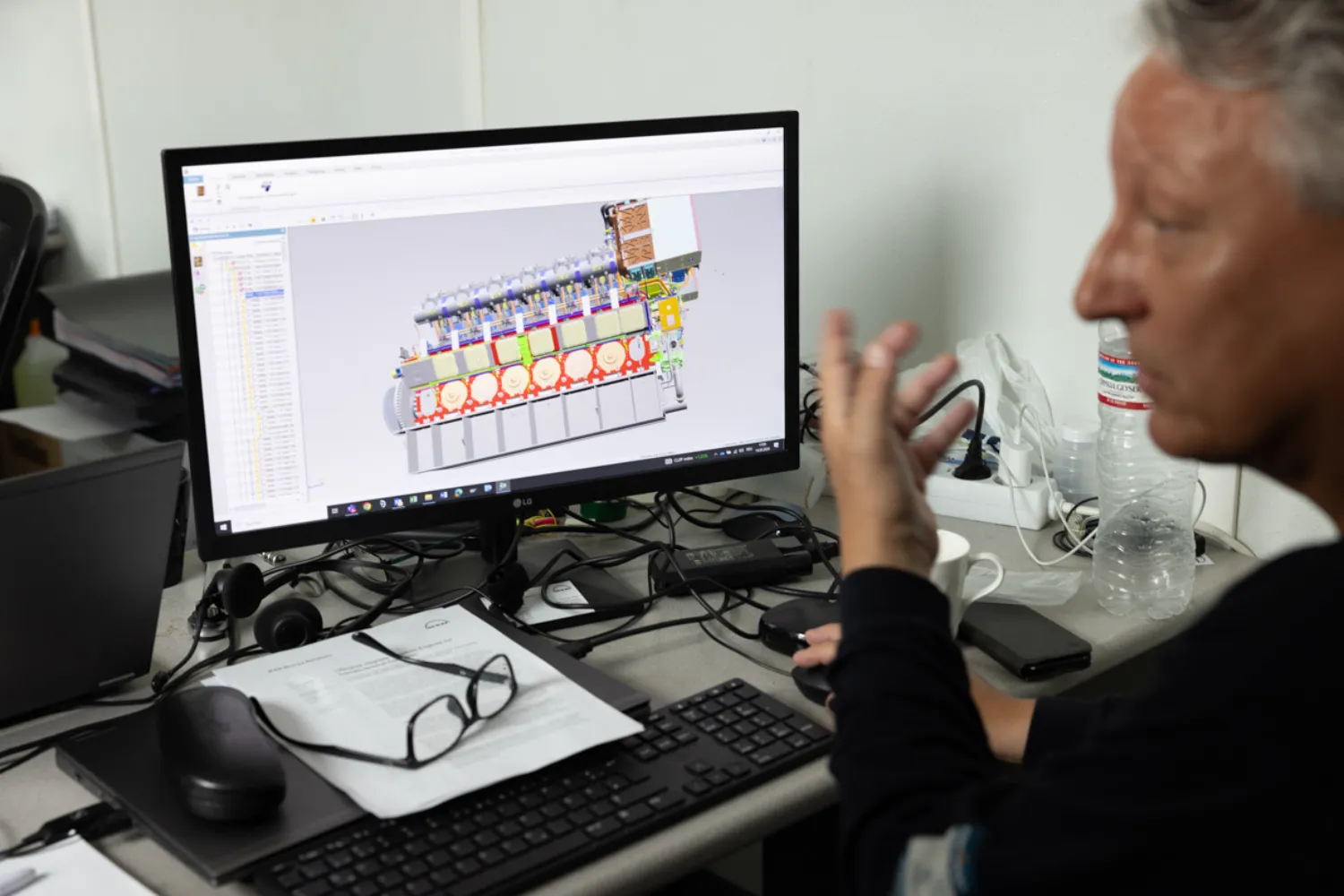 Thomas Sinz from Everllence works on a digital model of the 51/60 engine in a temporary office near the engine room on Grand Cayman.