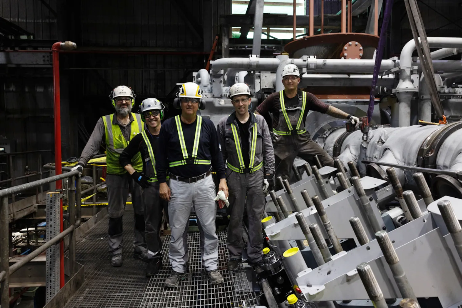 Group photo of Everllence PrimeServ engineers and technicians inside the engine room at the CUC power plant on Grand Cayman.