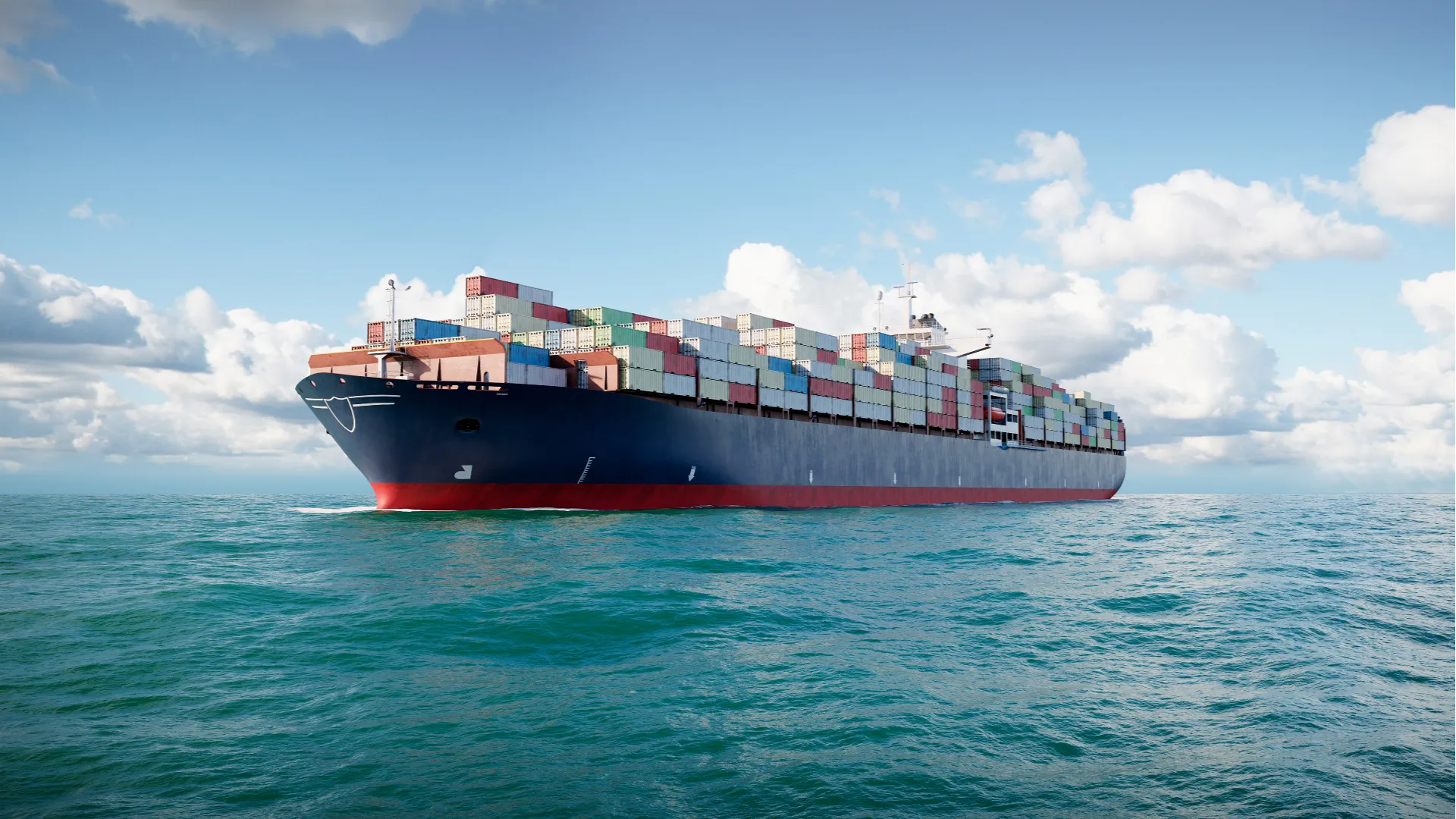 A large cargo ship sailing under clear skies, representing modern maritime vessels equipped with dual-fuel engines for reduced emissions.