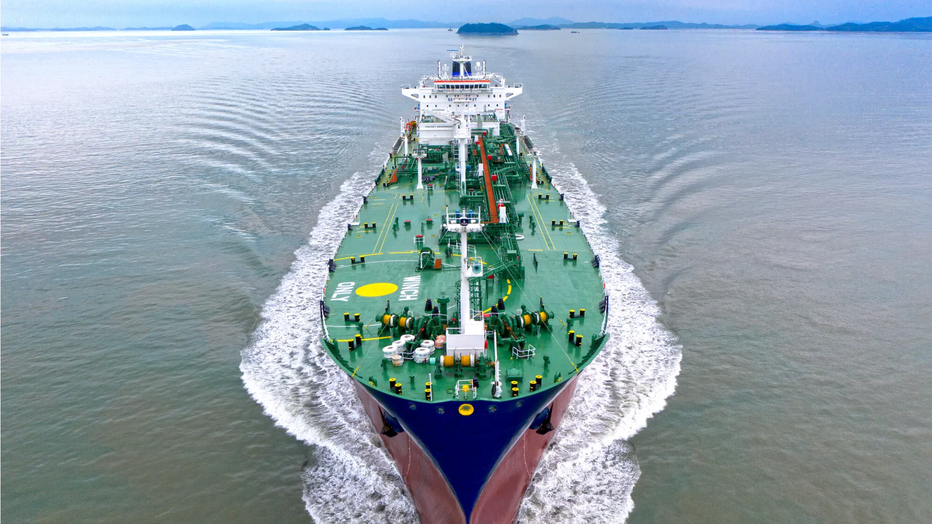 Aerial top-down view of a Trafigura container vessel loaded with cargo, highlighting the scale of international shipping and fuel efficiency potential.