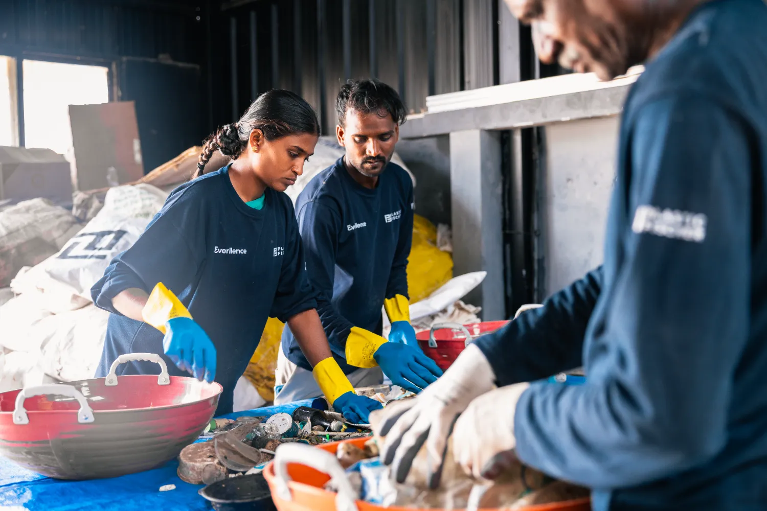 Workers manually sorting collected river waste at the Material Recovery Facility in Bengaluru, India.