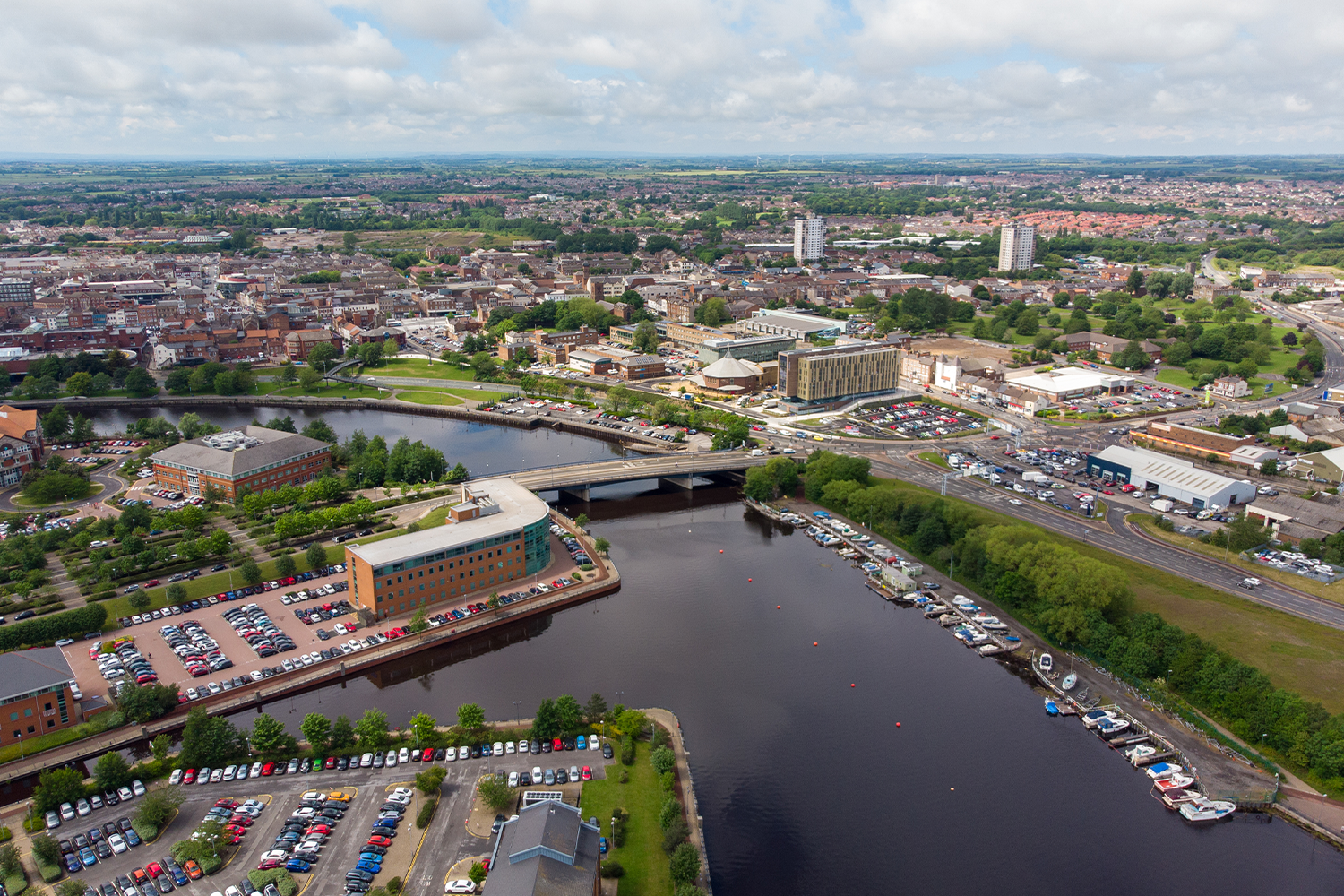 Aerial view of a city with a river and several buildings