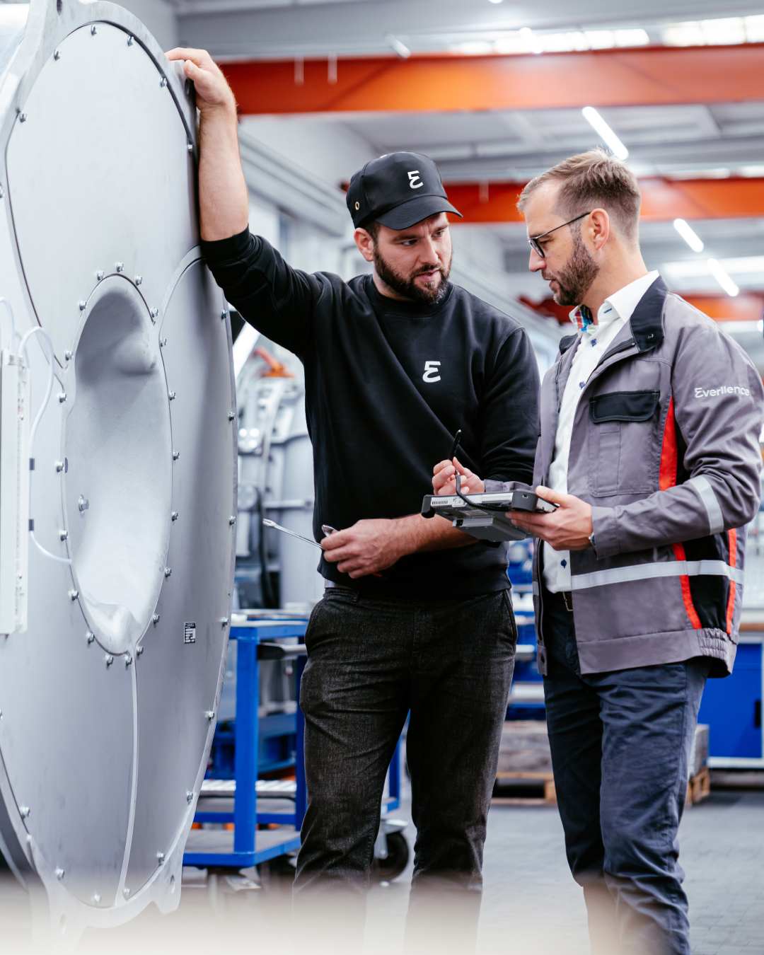 Two experts discussing equipment in the workshop