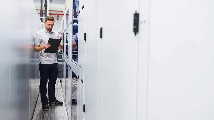 Man making notes in front of a machine