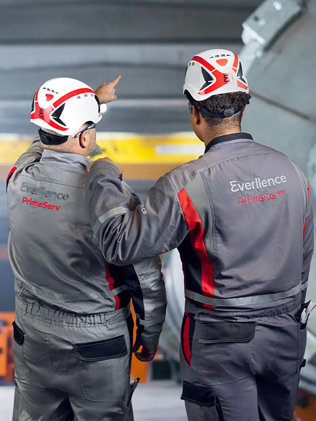 two service engineers from behind in Everllence workwear