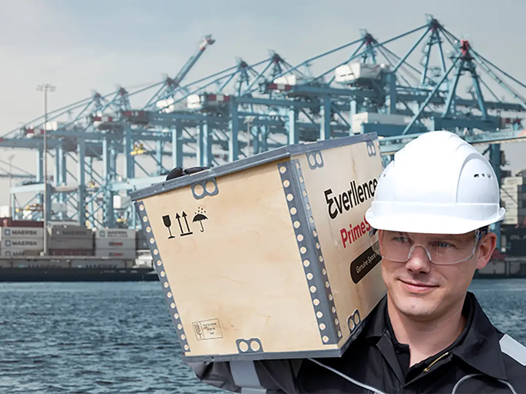 worker at habor with wooden box branded with Everllence