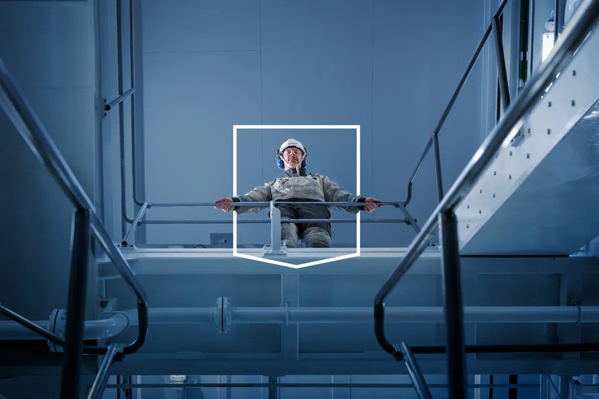 service employee on a ship looking down in the engine room