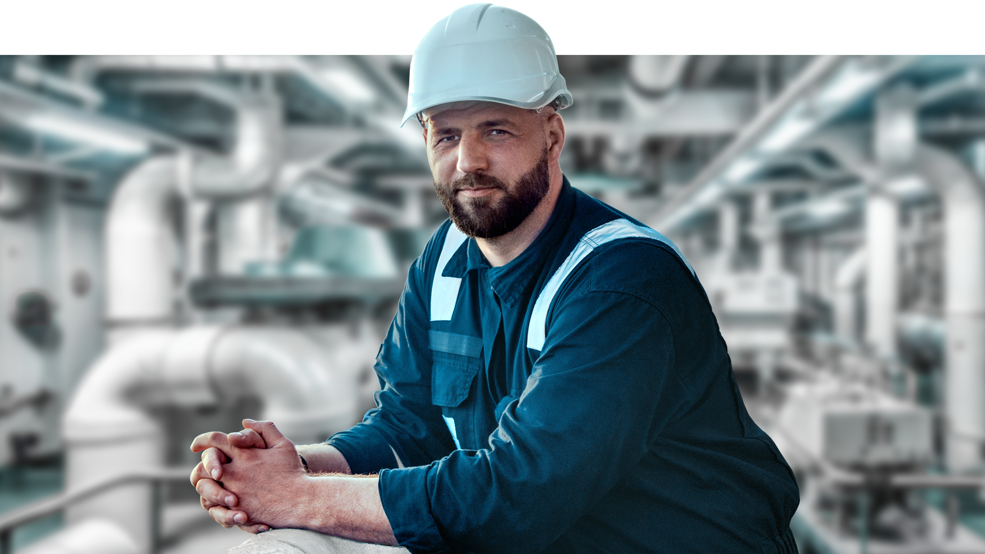 Engineer stands in machine room and looks relaxed