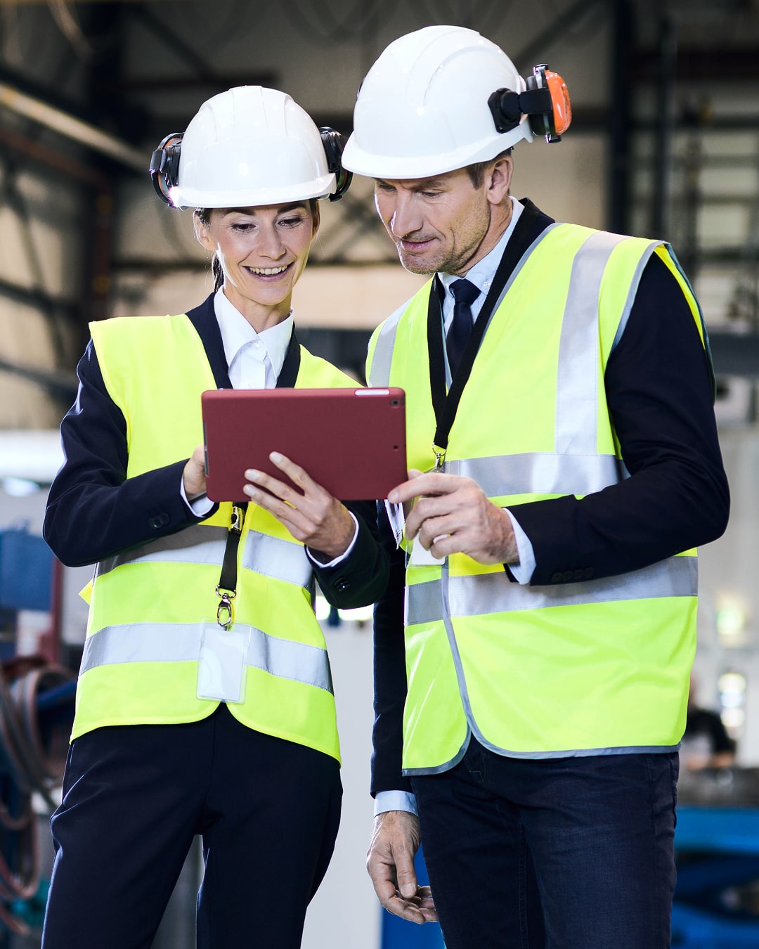 two serice employees looking at a tablet