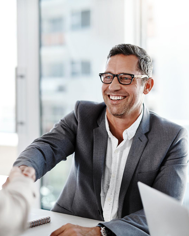 Man in suit shaking hands and laughing