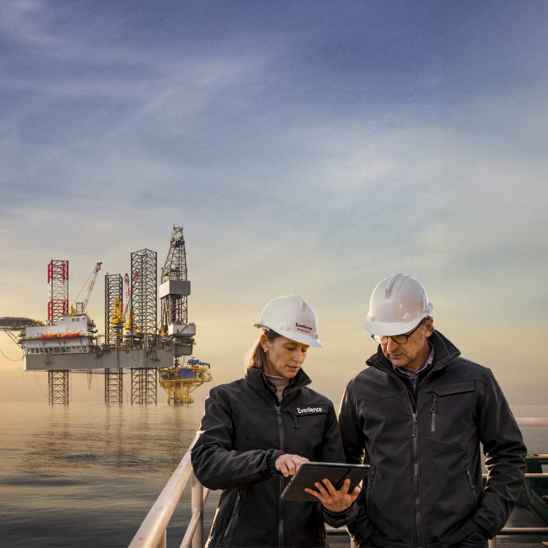 Two service people next to a offshore platform