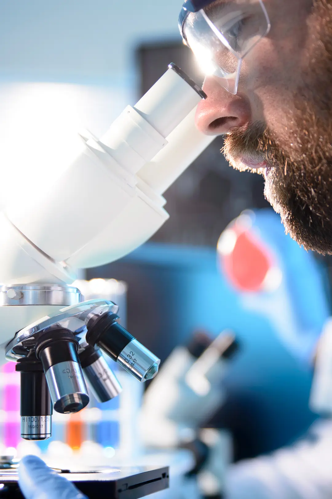 man looking into a microscope