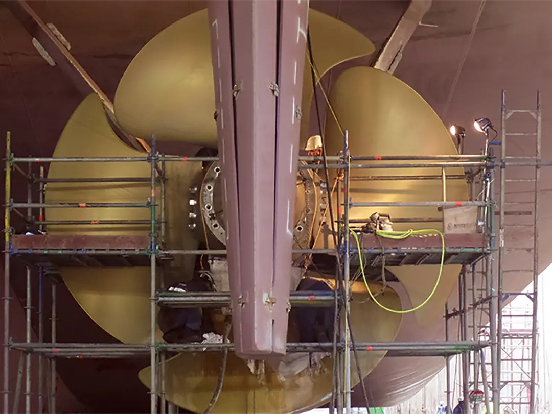 close up of a large propeller of a ship in dry dock