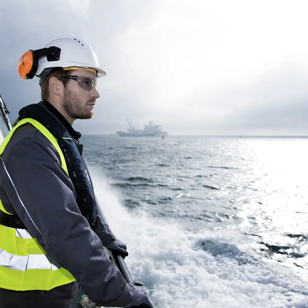 service employee on a ship looking on the sea
